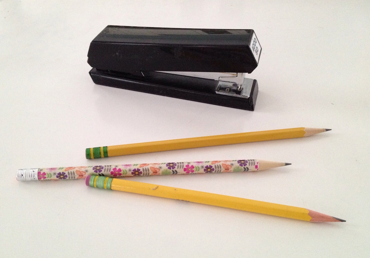<p>Photograph of 3 pencils and a stapler </p>
