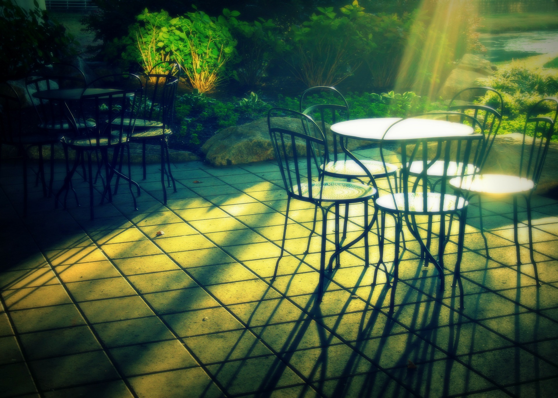 Photograph of patio. Floor paved with square tiles. 