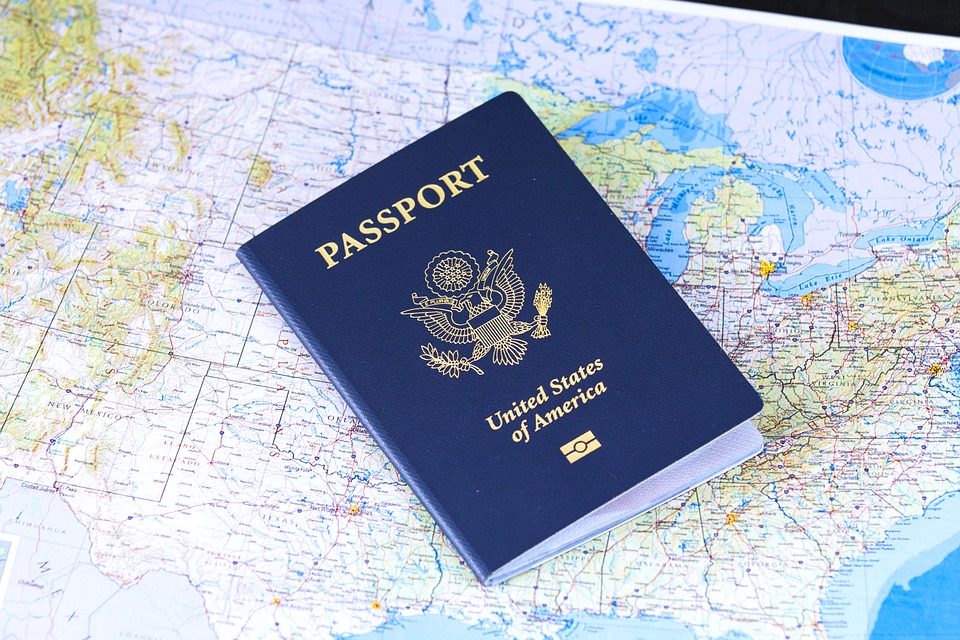 <p>US passport on world map background</p>
