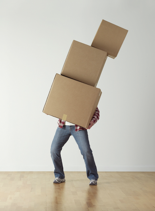 <p>man balancing different sized boxes</p>
