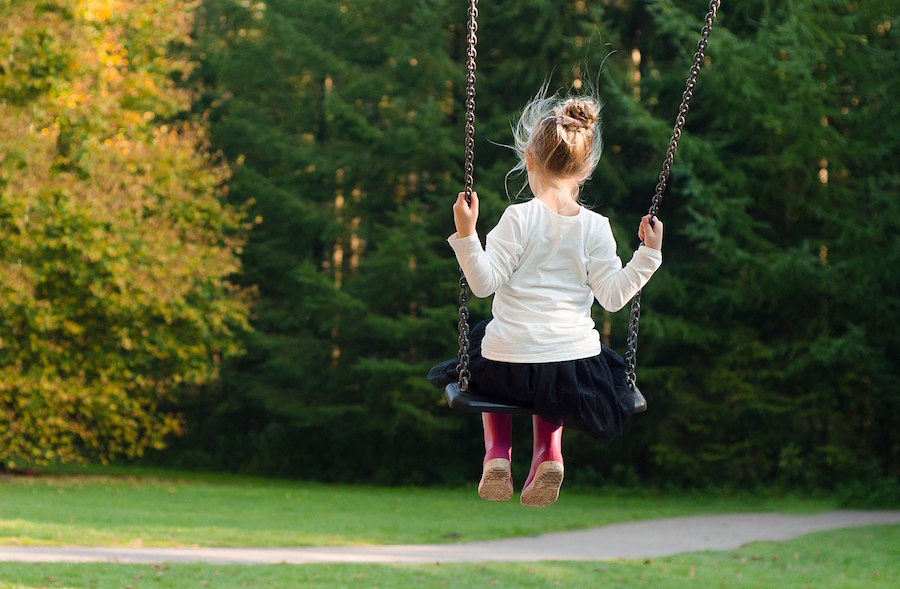 <p>A girl on a swing. </p>
