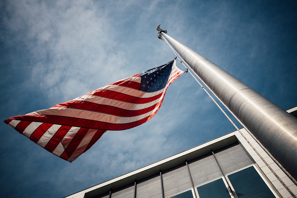 <p>a US flag being raised</p>
