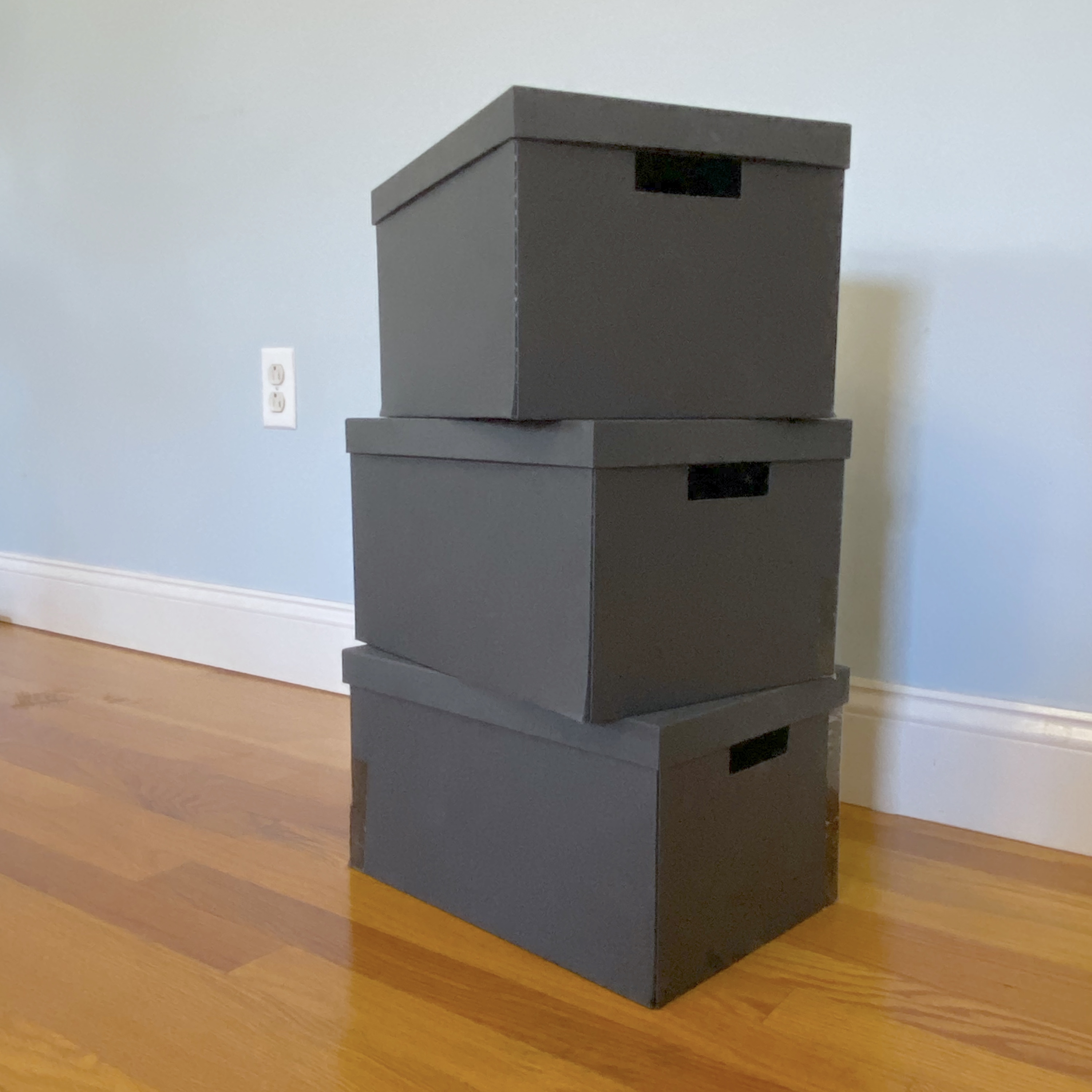 <p>Photograph of 3 stacked cardboard boxes</p>
