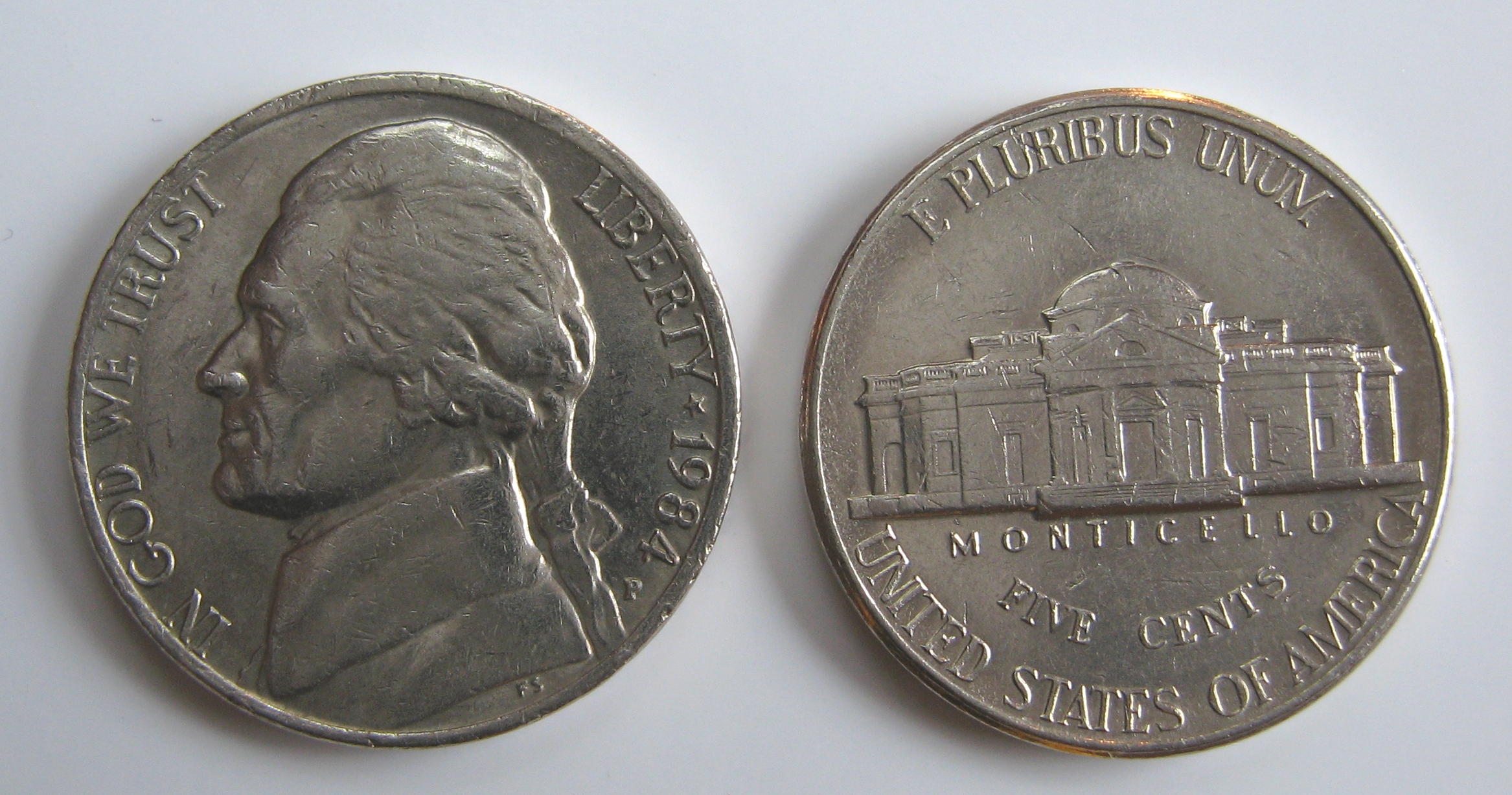 <p>photo of a nickel showing both the heads and tails sides</p>
