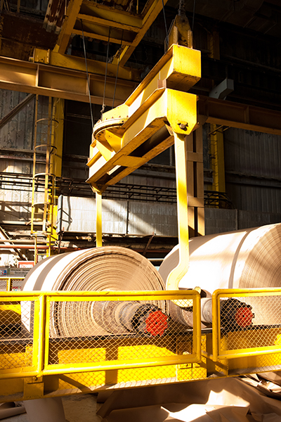 A picture of paper being made on two large rollers.