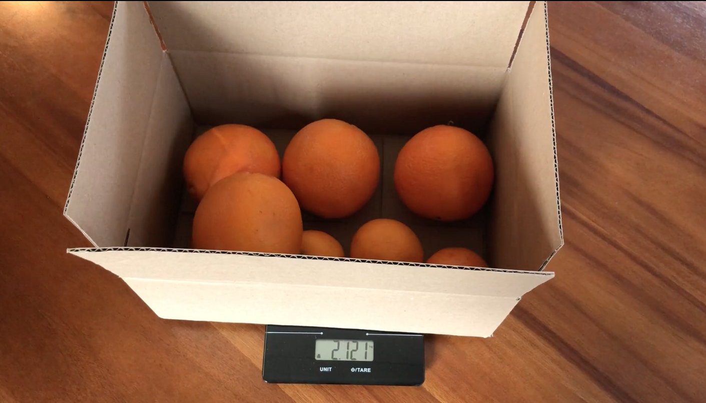 <p>Video still of oranges being weighed</p>
