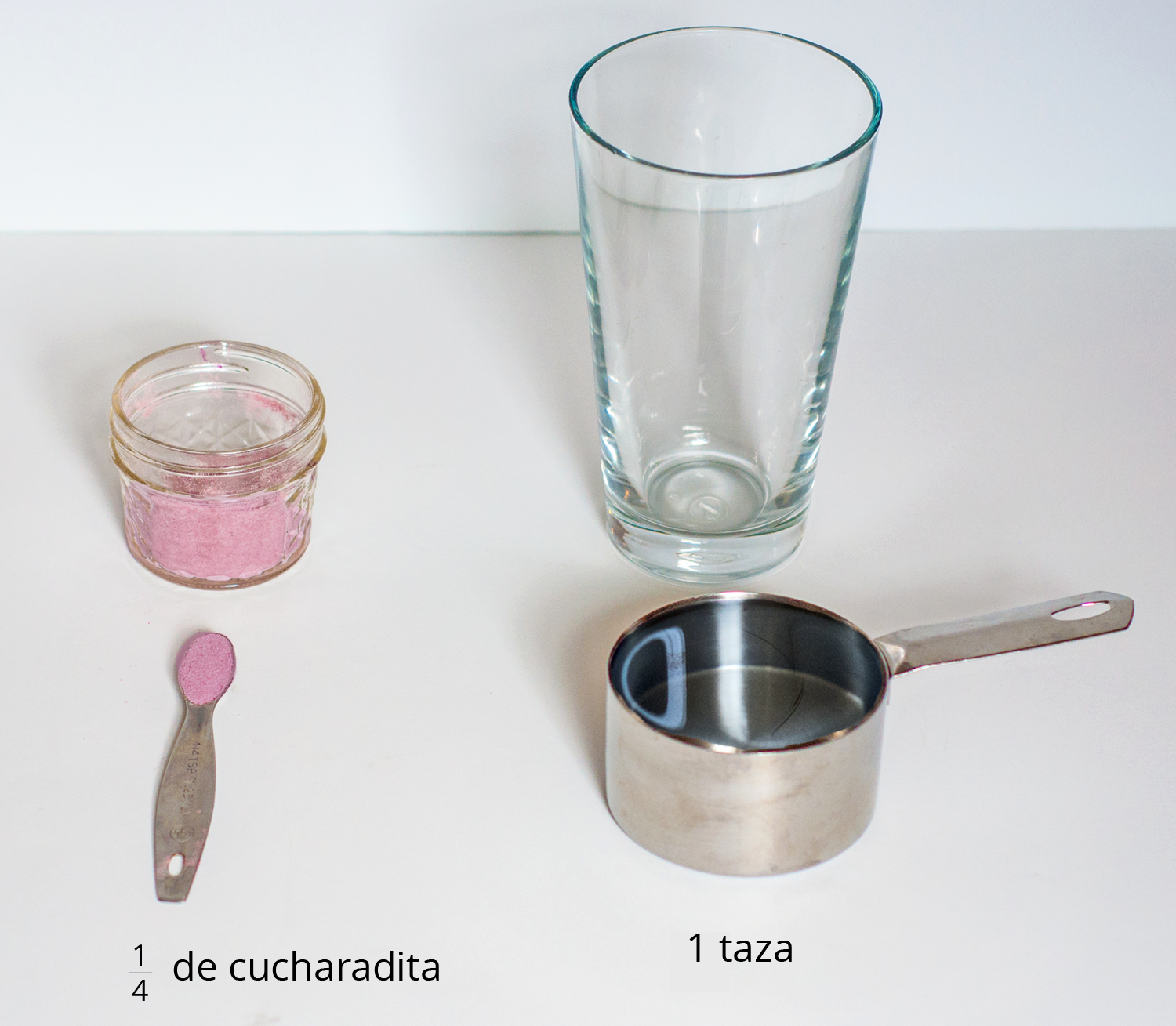 A picture of a glass, drink mixture in a container, a quarter teaspoon of drink mix, and a measuring cup.