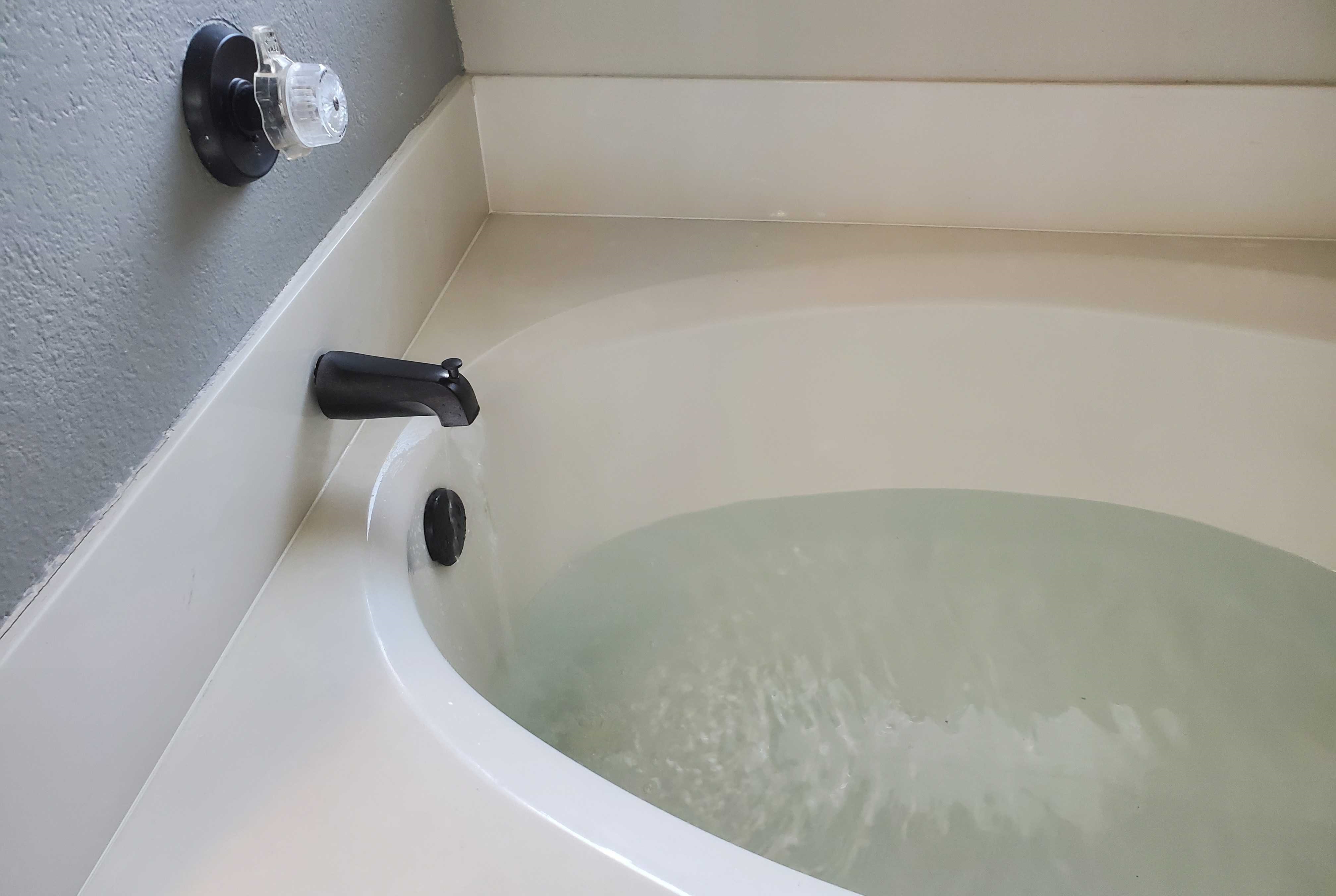 Image of water filling a bathtub.