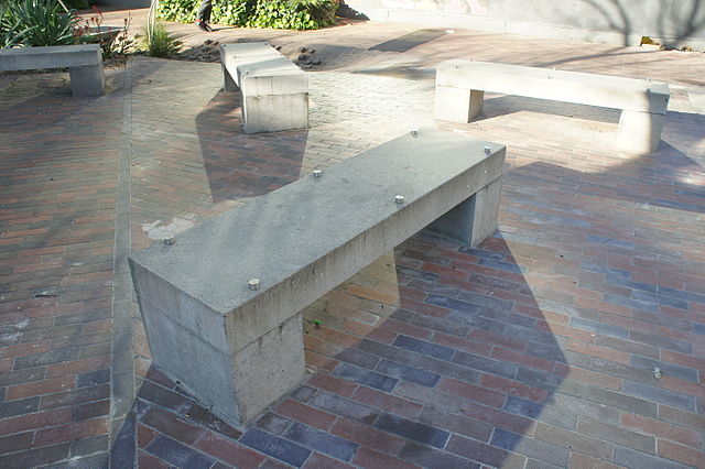 <p>A concrete bench formed by two rectangular prism supports, each the same width as the rectangular prism bench seat.</p>
