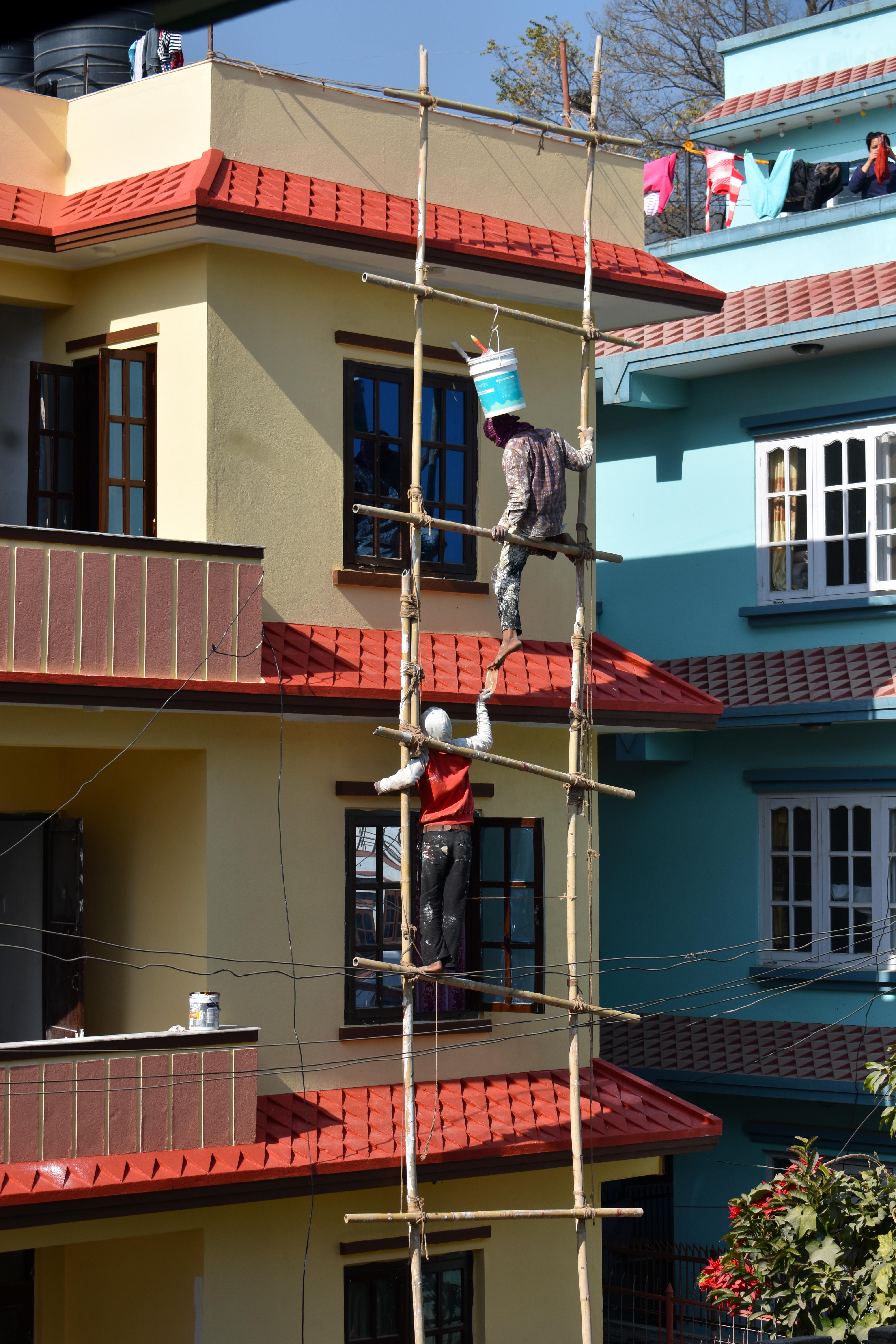 <p>A photo of two people on a ladder. The ladder two vertical posts and 5 visible rungs, running horizontally across.</p>
