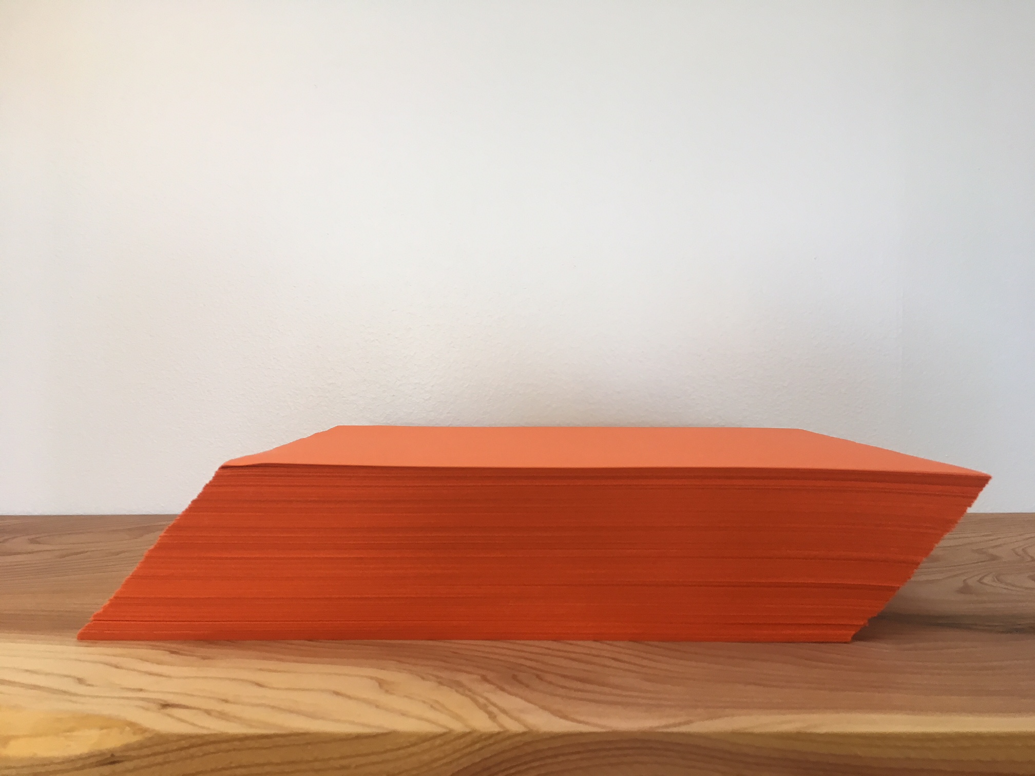 <p>A ream of orange paper, slanted to the right. </p>
