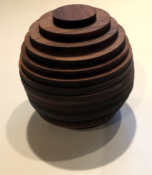 <p>A photo of a stack of discs that approximates a sphere.</p>
