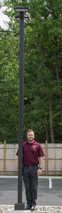 <p>Image of six foot adult man next to lamp post. Lamp post is taller than man.<br>
 </p>
