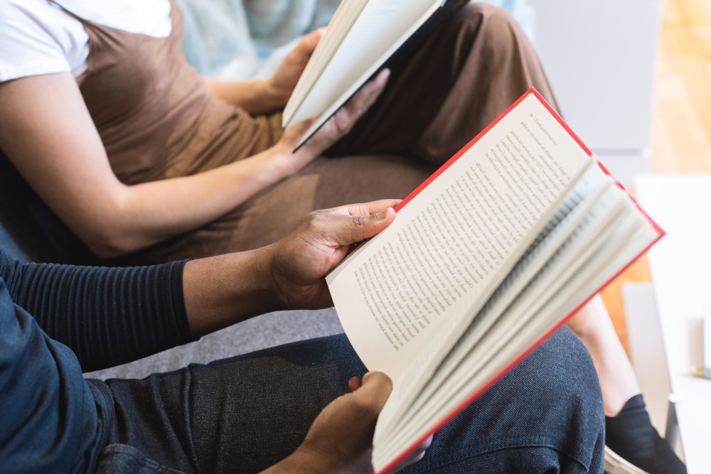 <p>Two students reading while sitting</p>
