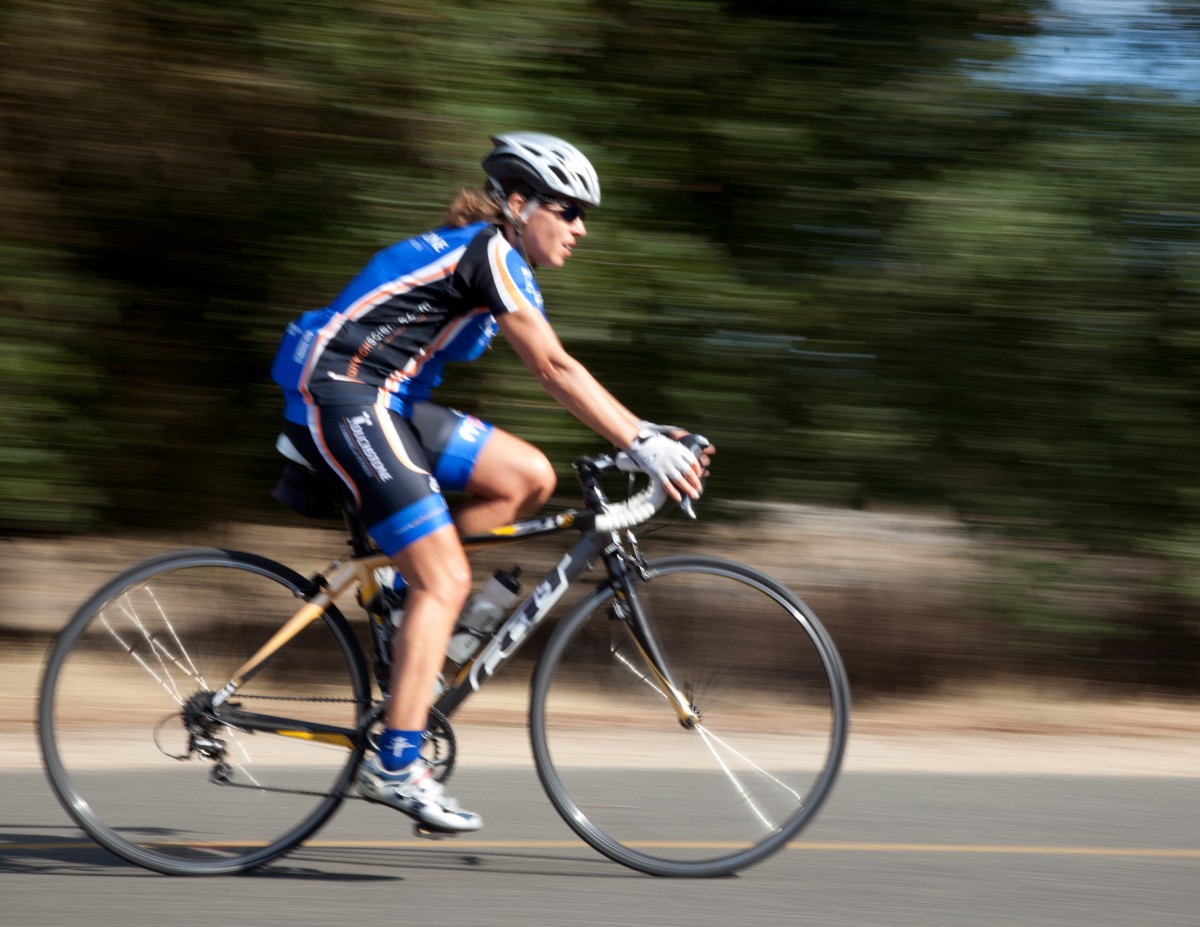 <p>A woman biking.</p>
