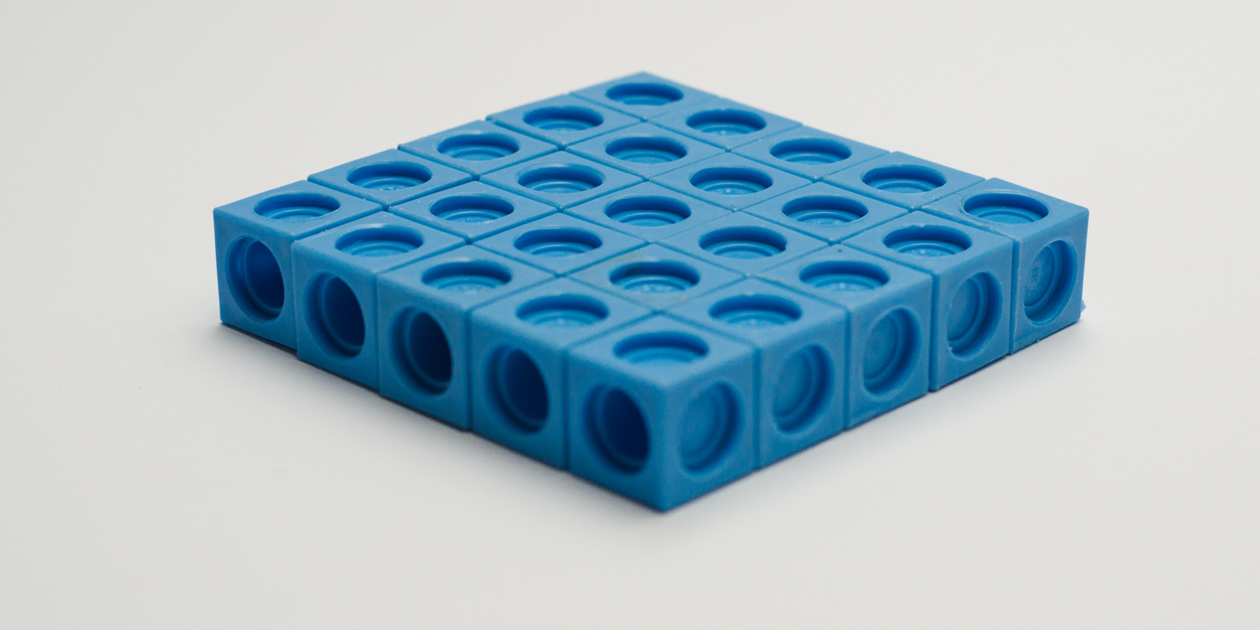 <p>A photo of a prism made up of interlocking cubes. Each side is 5 cubes long. The prism is 1 cube tall. </p>
