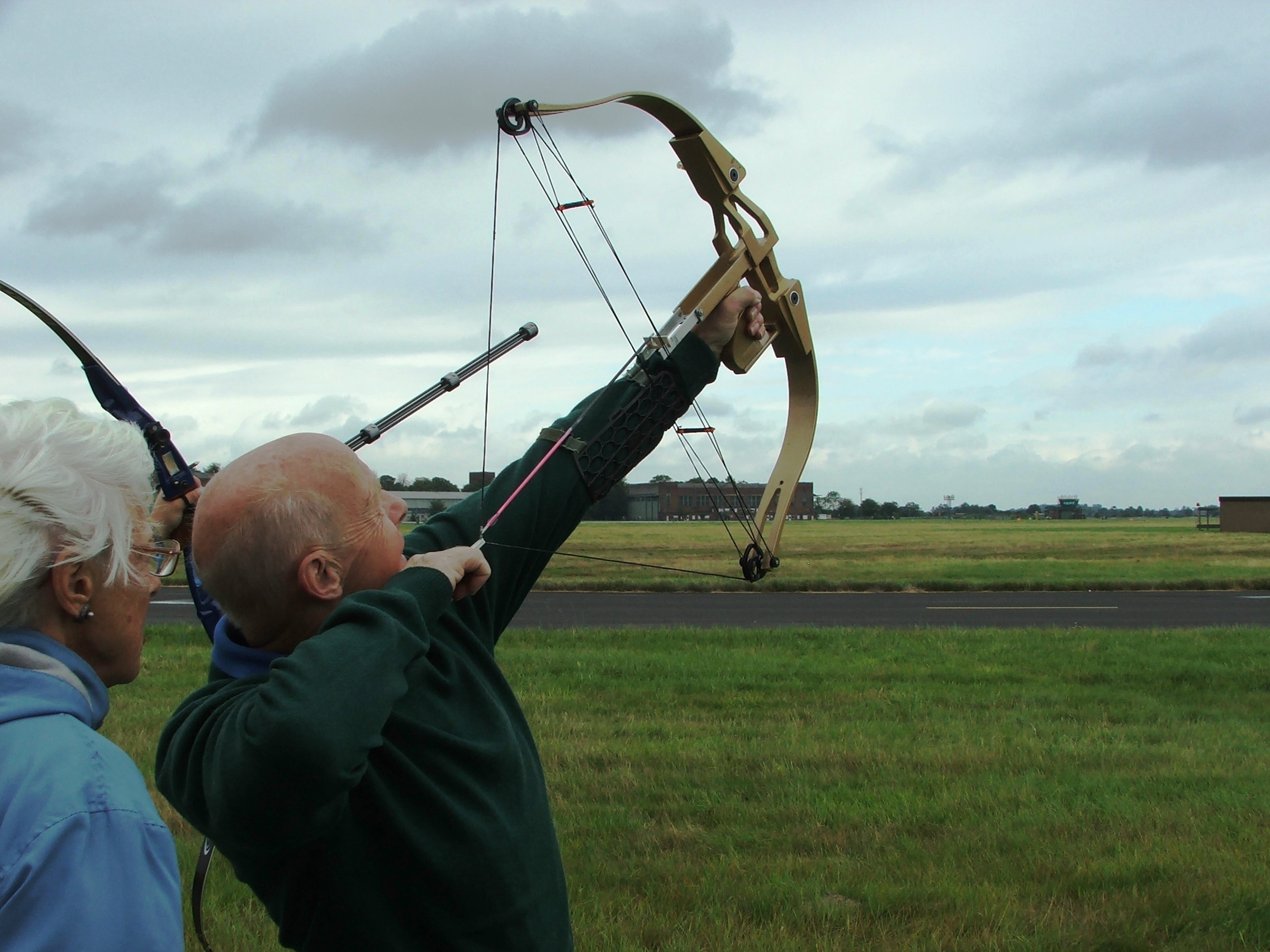 <p>man shooting bow and arrow into the sky.</p>
