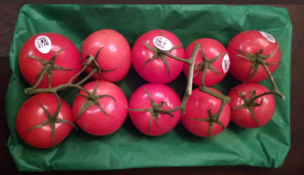 A photograph of 10 red tomatoes of a similar size. Top row has 5 tomatoes. Bottom row has 5 tomatoes.
