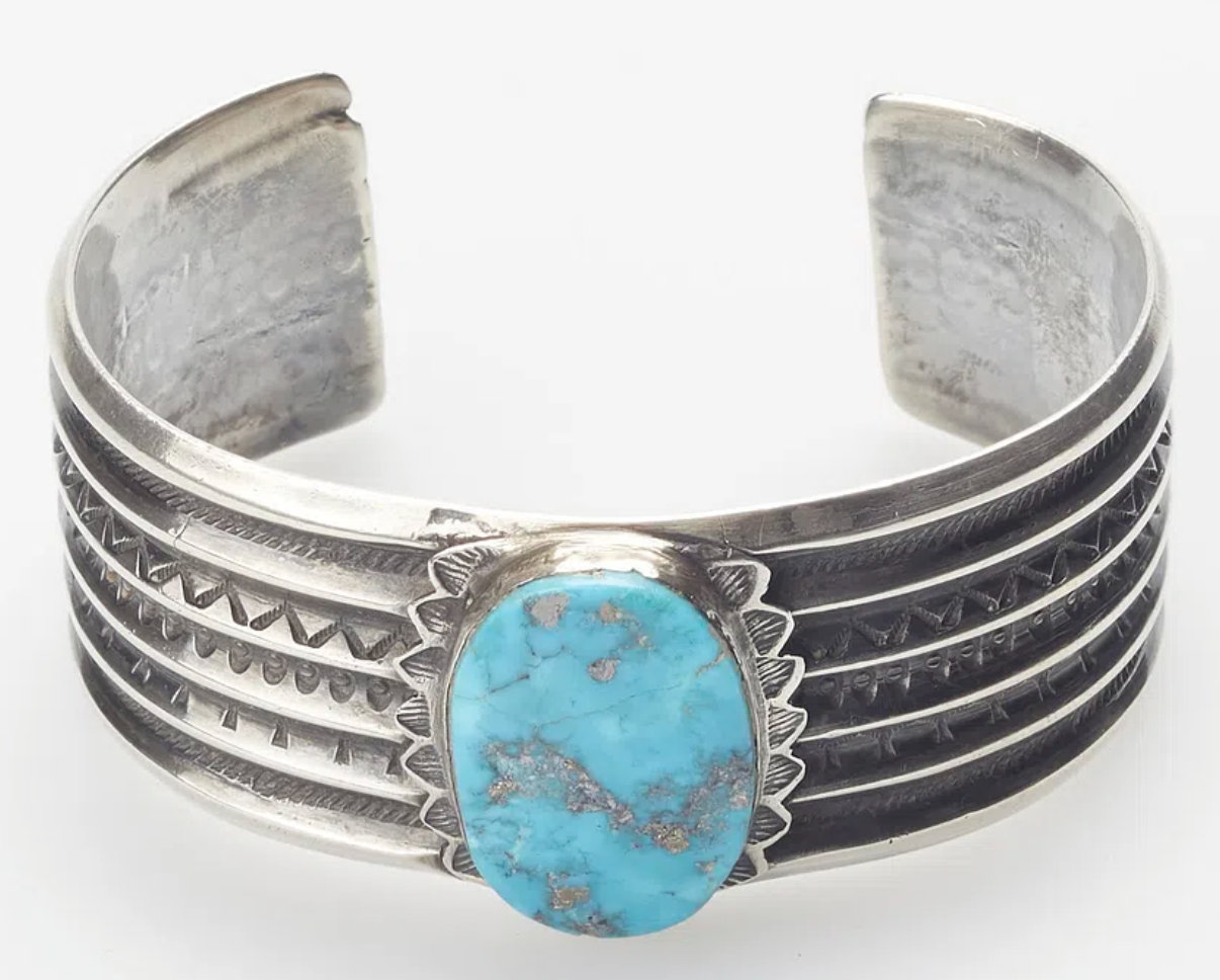 Silver bracelet with large turquoise stone in the center
