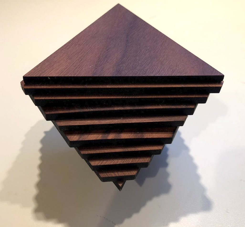 <p>Photograph of stacks of triangular wood pieces </p>
