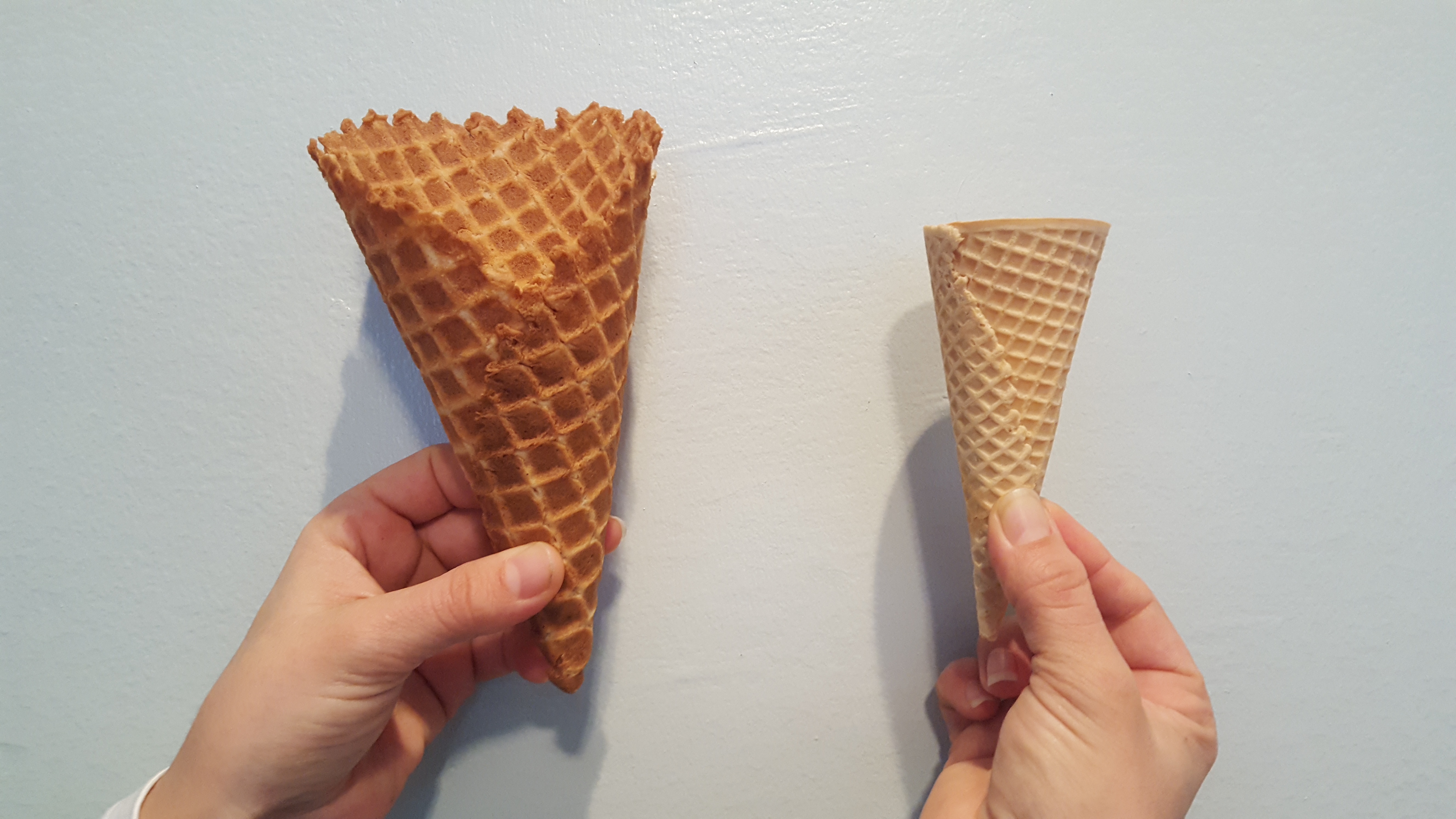<p>Photo of two different ice-cream cones.</p>

