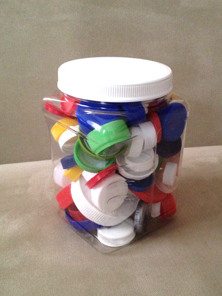 <p>A photo of a jar of bottle caps. </p>
