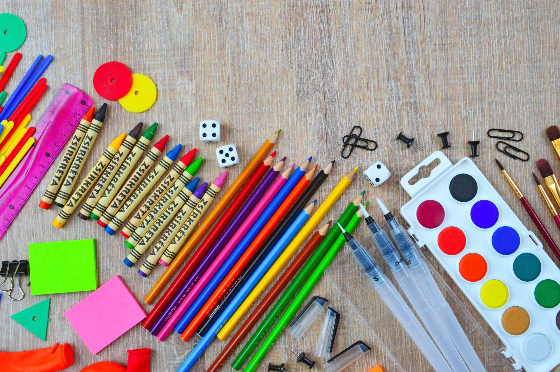Art supplies, pencils, crayons, paint, paint brushes, number cubes, sticky notes, paperclips.