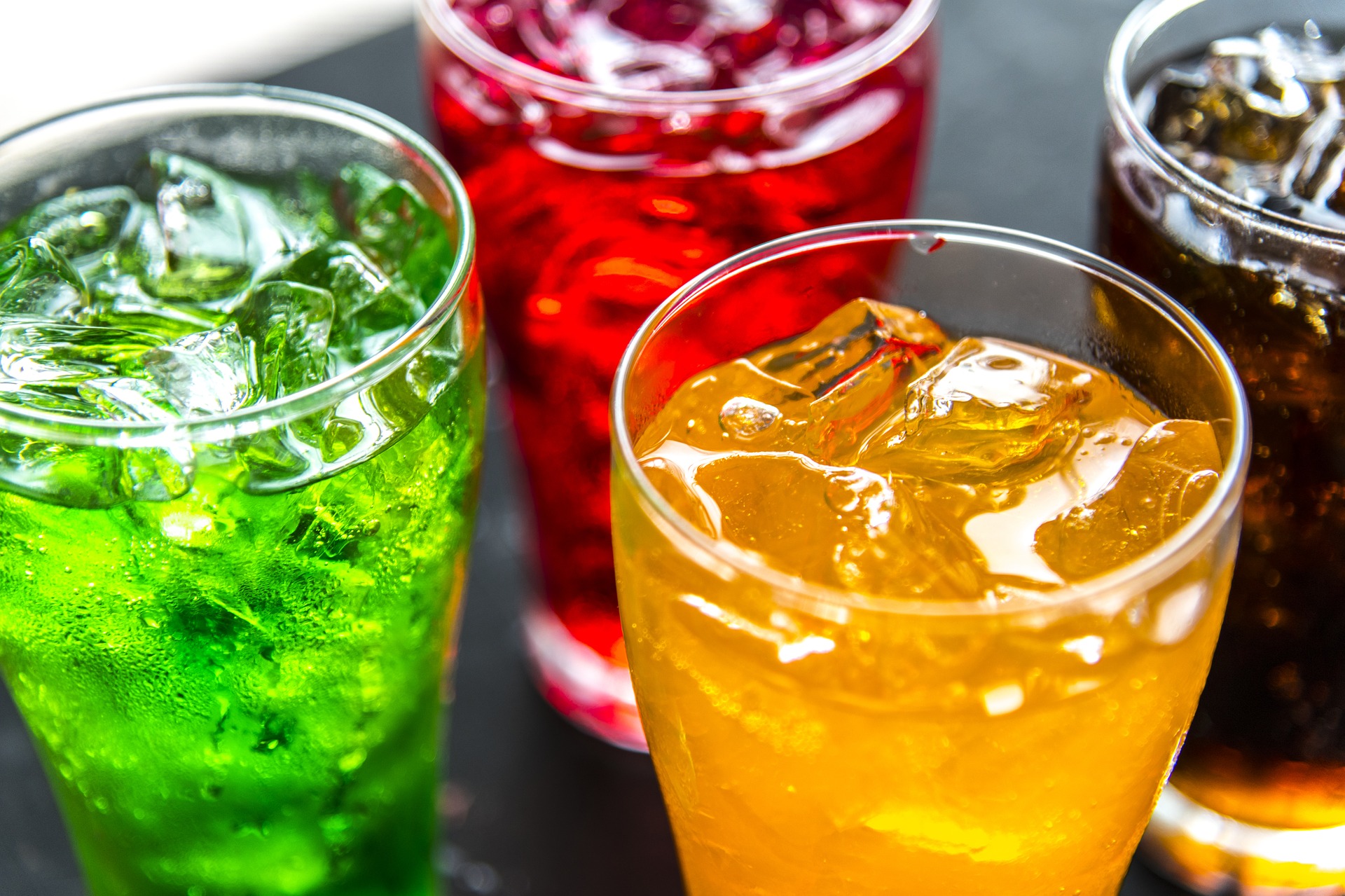 <p>a photo of four glasses of colorful, fizzy beverages</p>
