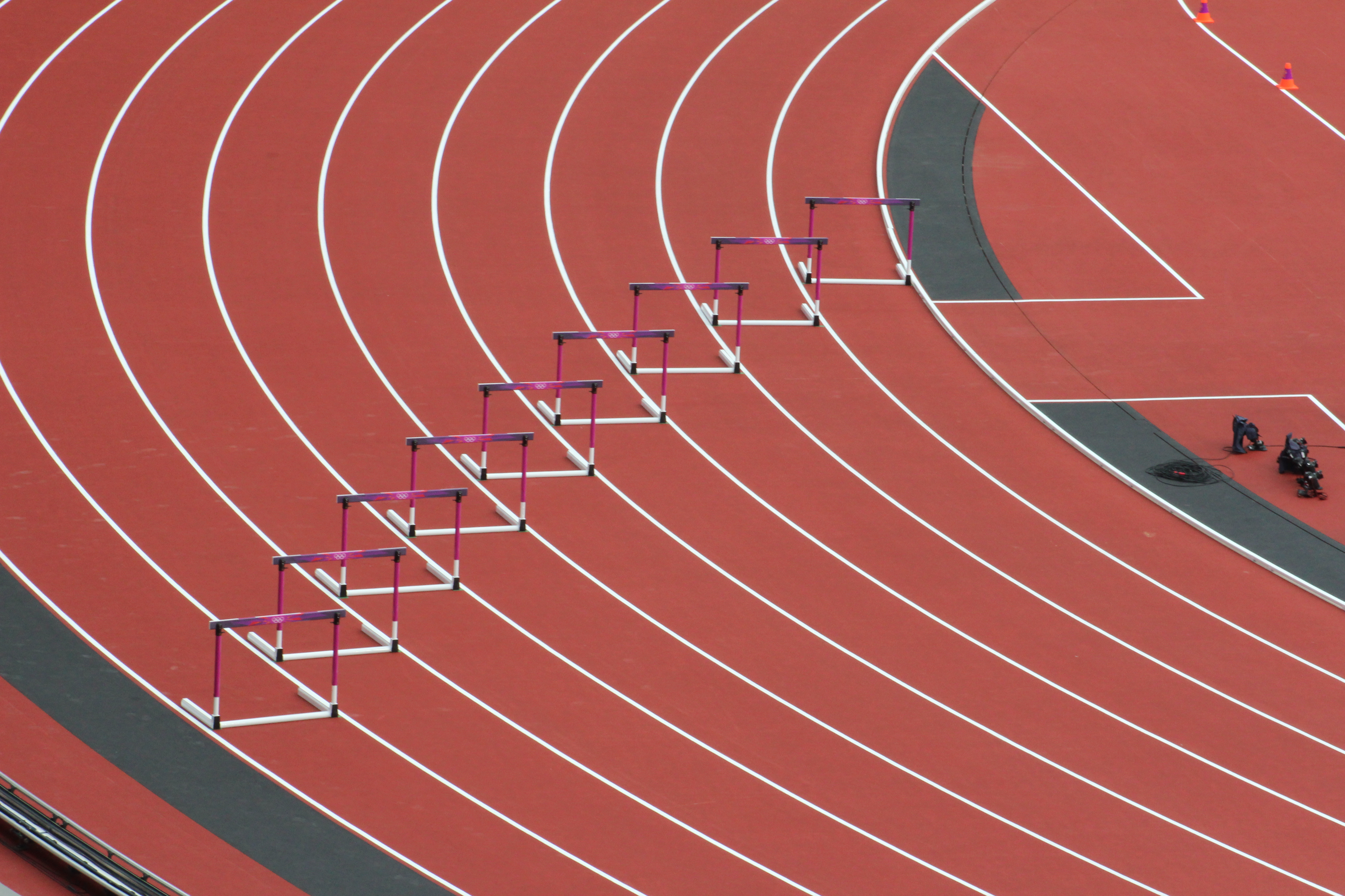 <p>photo of empty track with hurdles</p>
