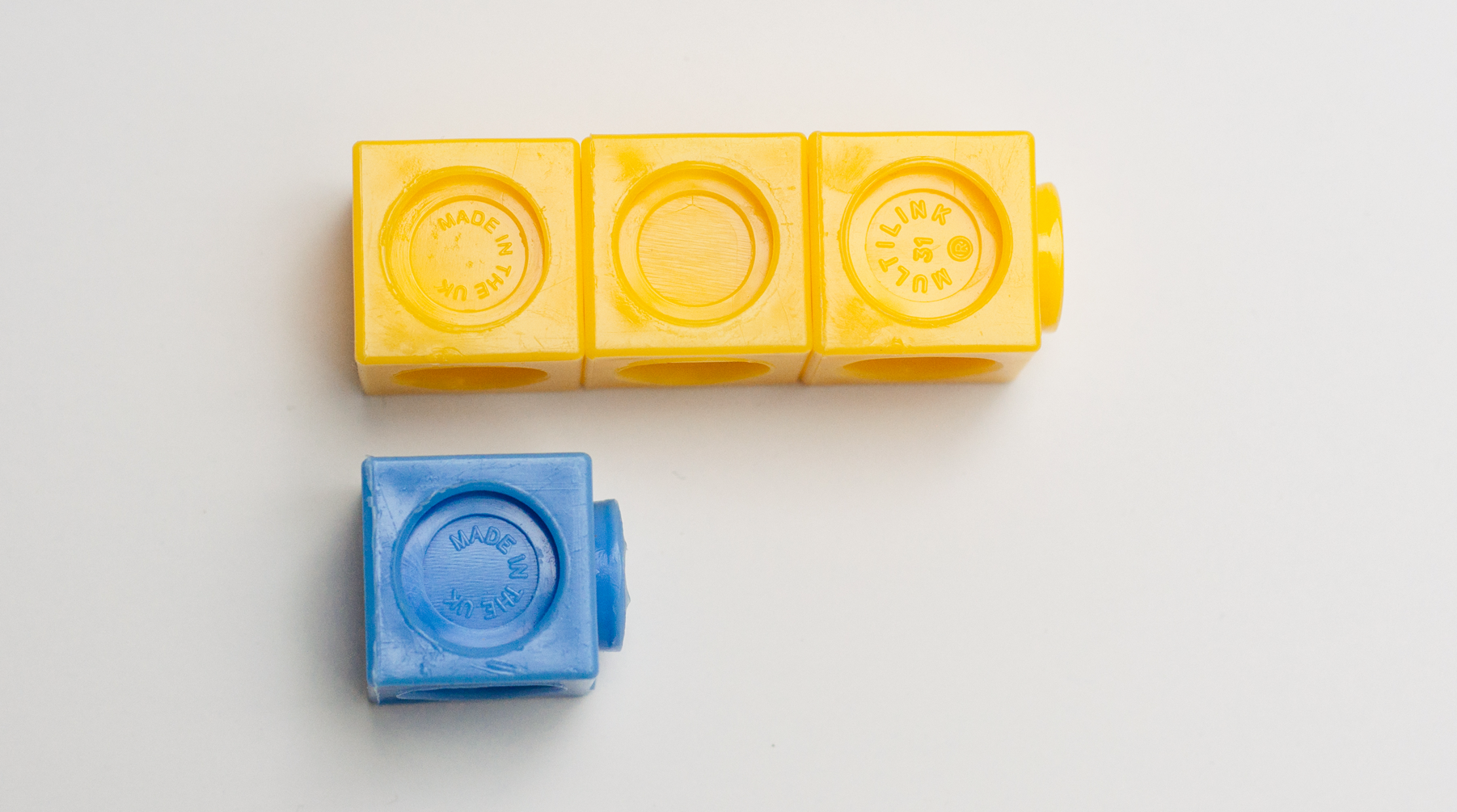 <p>Picture. Interlocking cubes. 3 yellow. 1 blue. </p>
