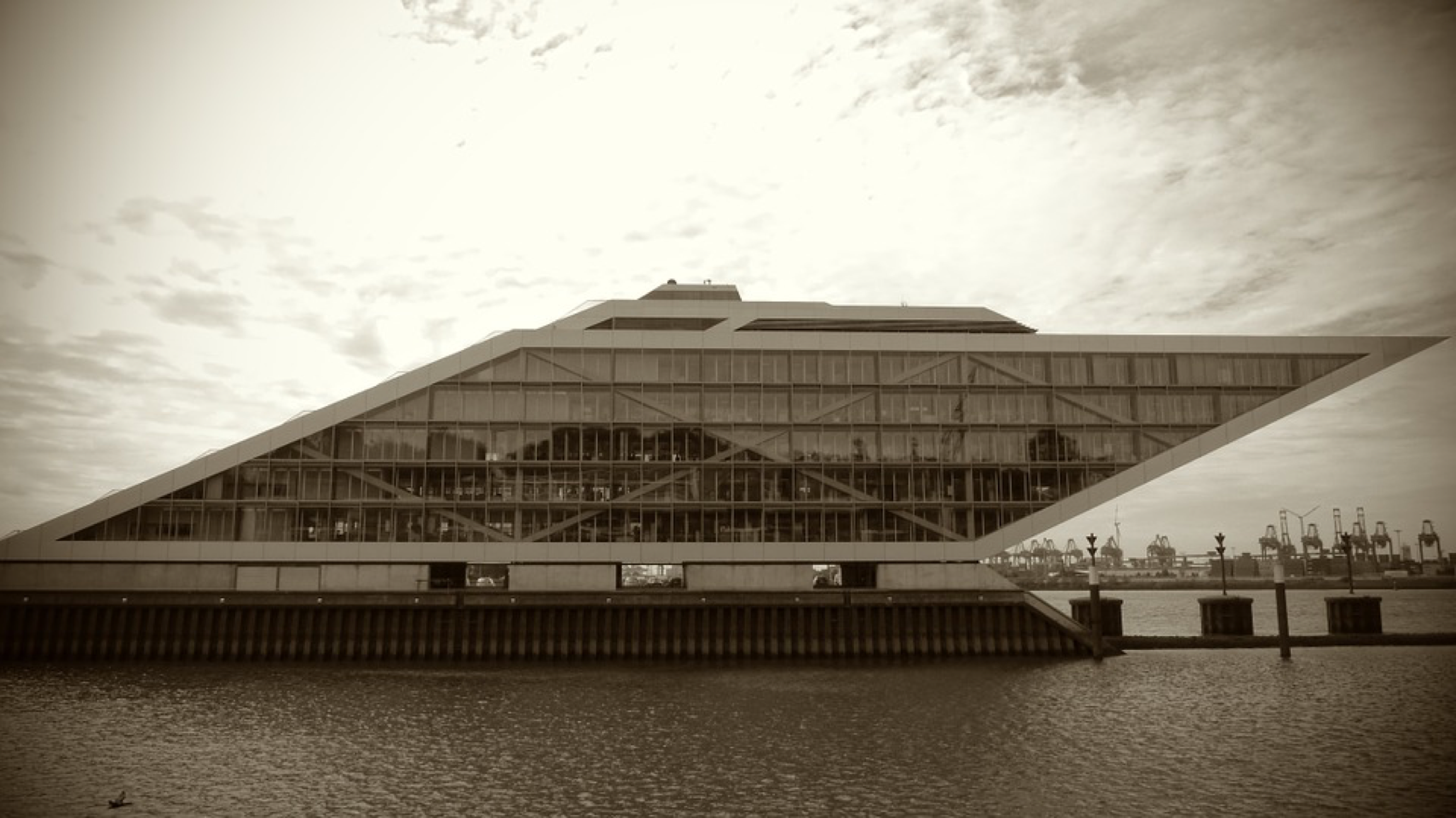 <p>A photograph of the Dockland Building in Hamburg, Germany. The building is shaped like a parallelogram.</p>
