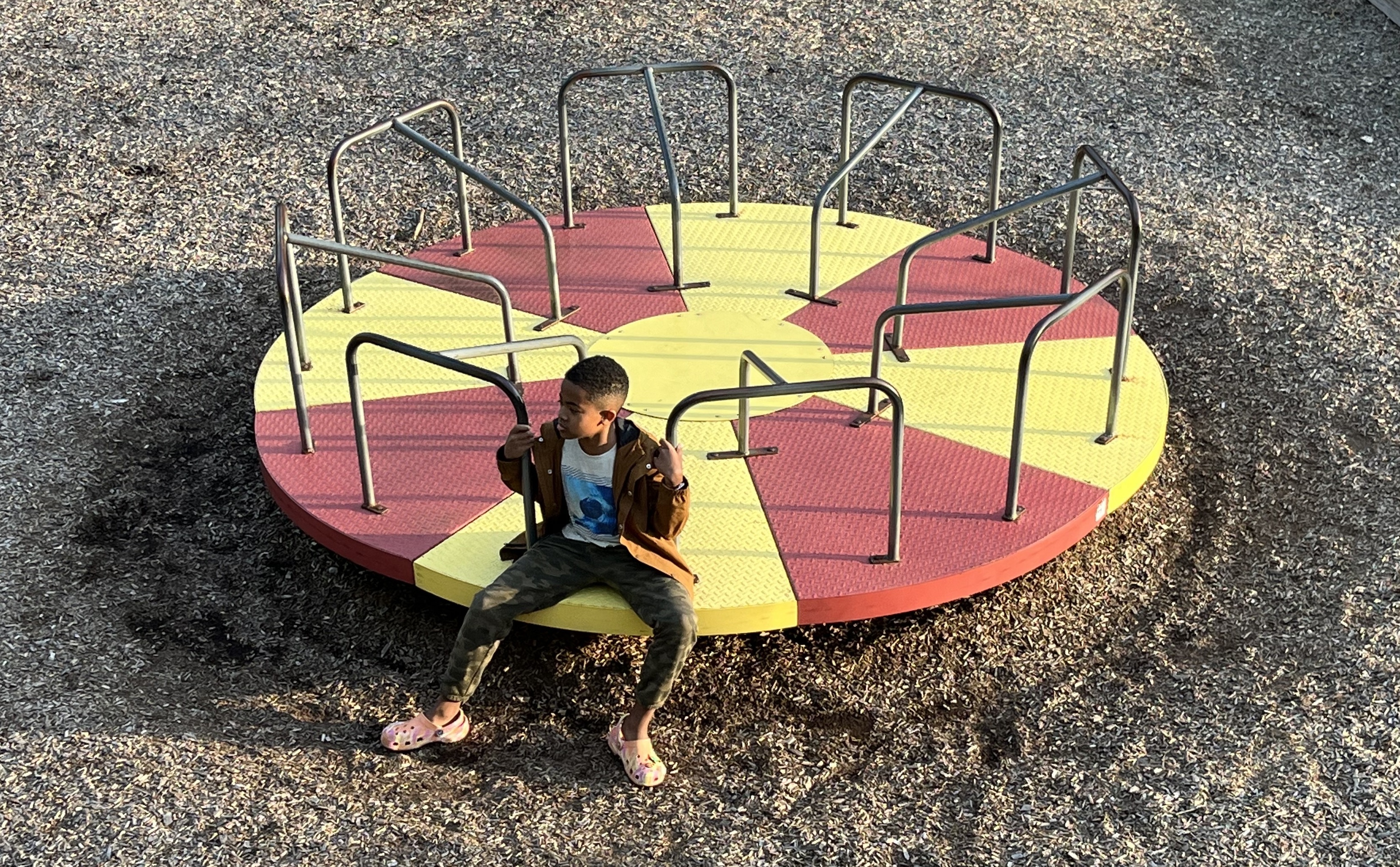 Image of a person on a circular merry-go-round.